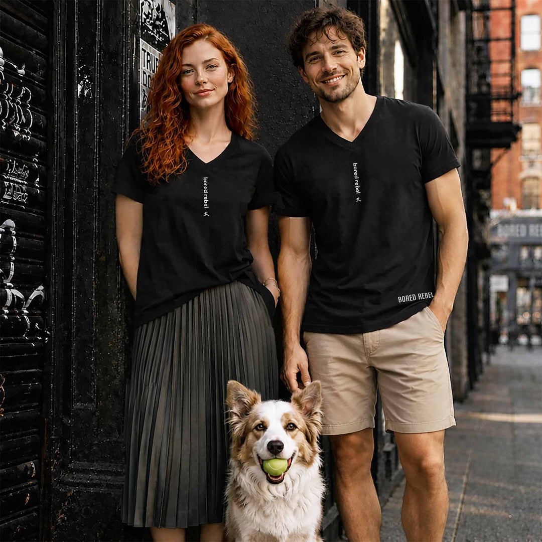 Man and woman each wearing Bored Rebel bored rebel graphic tee walking with dog in SoHo