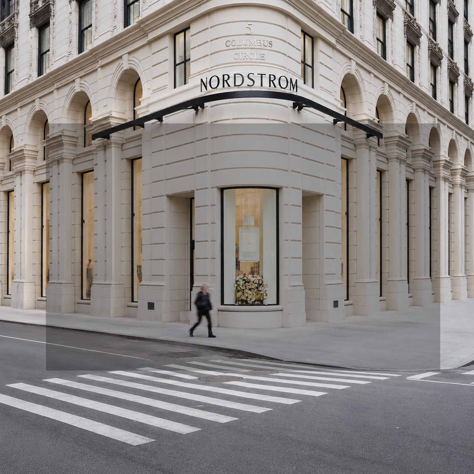 Nordstrom store front on a New York City street with a pedestrian crossing in the foreground.
