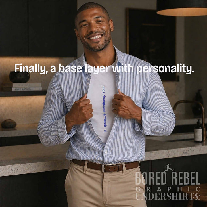 Man revealing Bored Rebel dogs, champagne &amp; friends patented graphic tee as base layer in luxury kitchen