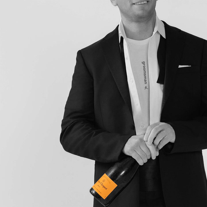 Man in a tux with dress shirt open, revealing a Bored Rebel men&