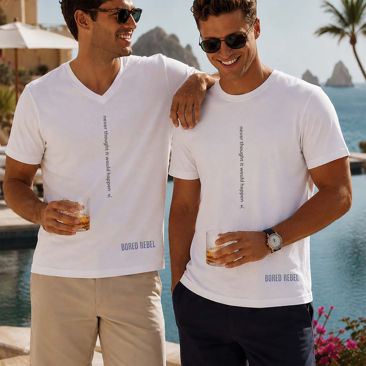 Two men at an upscale tropical resort in white Bored Rebel graphic tees — one crewneck, one V-neck — featuring a minimalist vertical saying on their chests that reads &